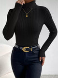 Woman wearing a black ribbed turtleneck sweater
