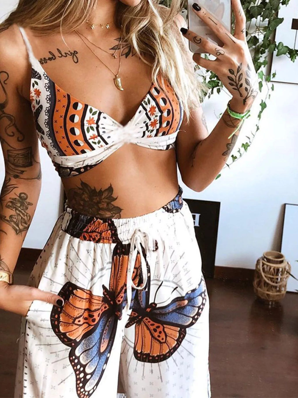 Woman wearing a two piece butterfly boho top and pants set