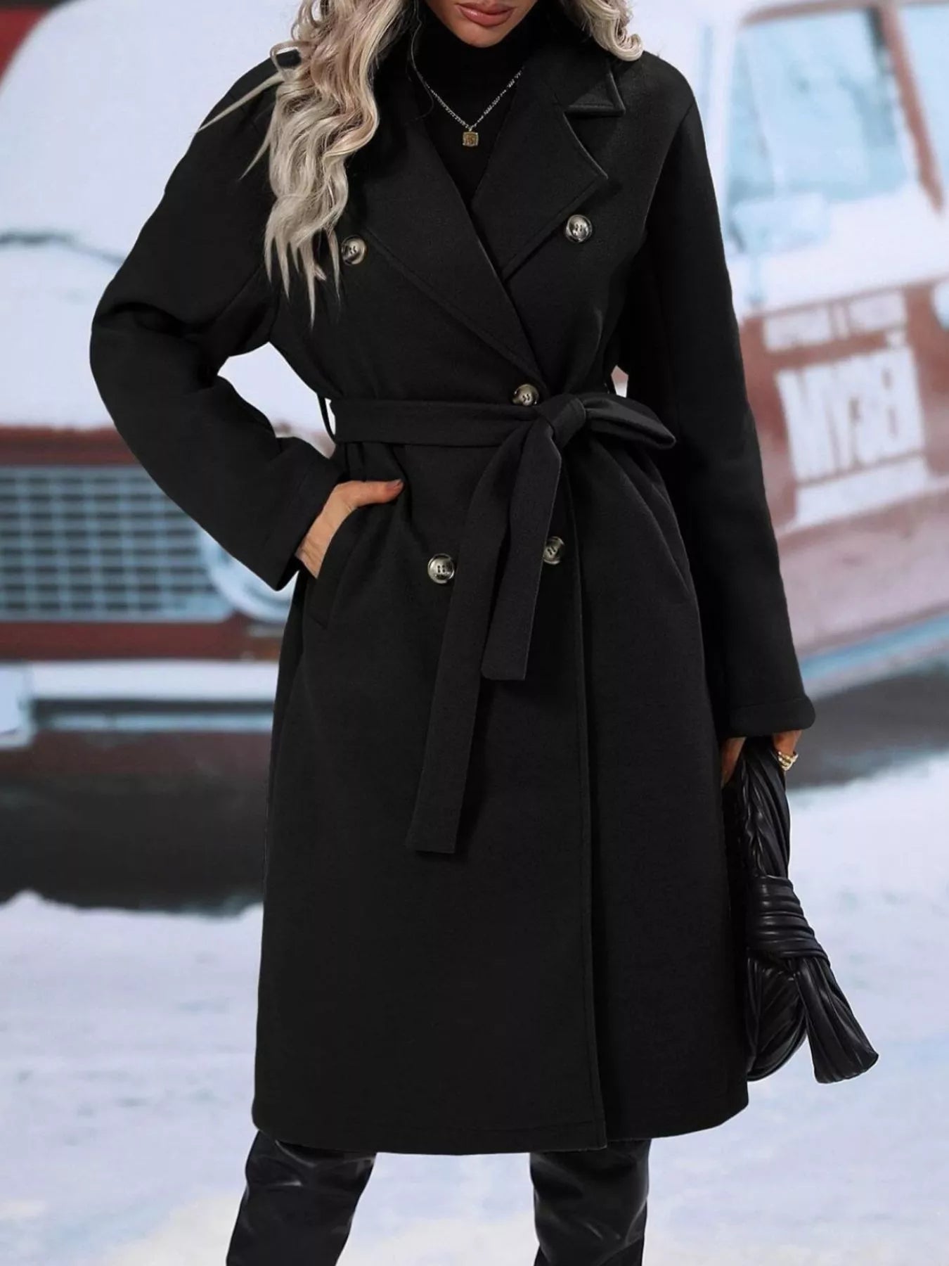 Woman wearing a black button up tie waist coat