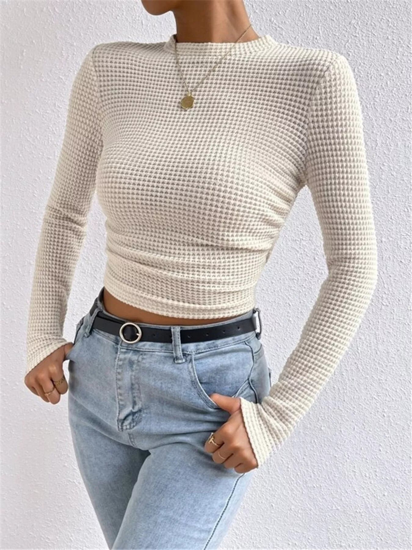Woman wearing a tan waffle knit fitted long sleeve tee