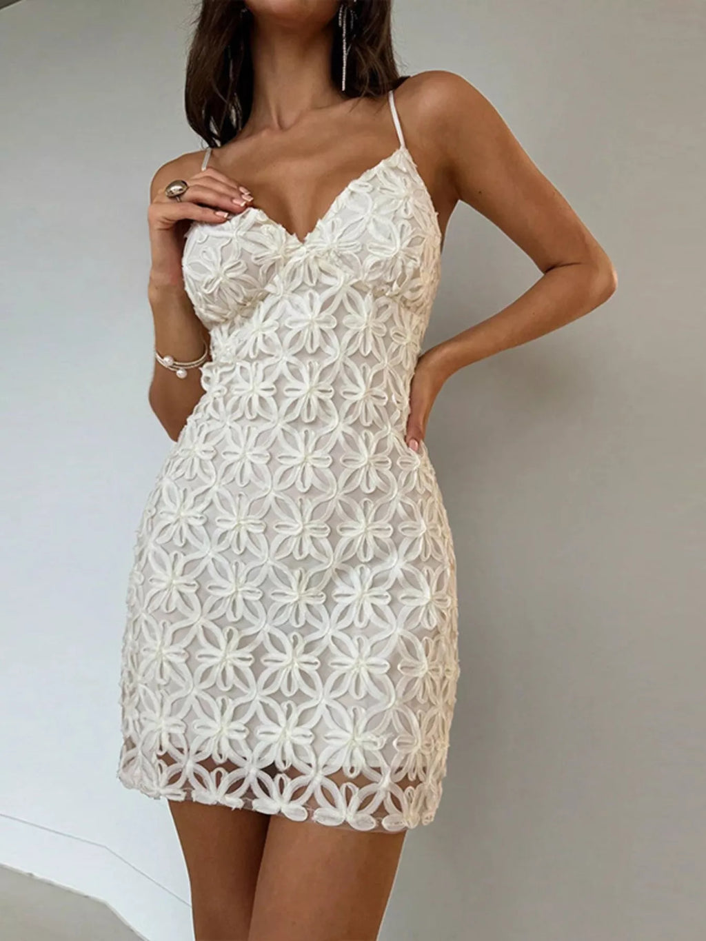 Woman wearing a white lace bodycon mini dress