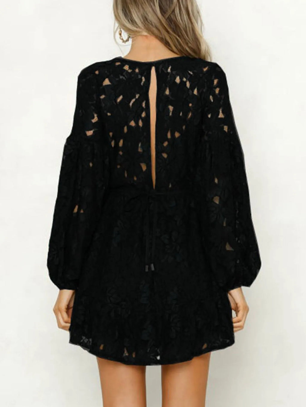Woman wearing a lace long sleeve mini dress
