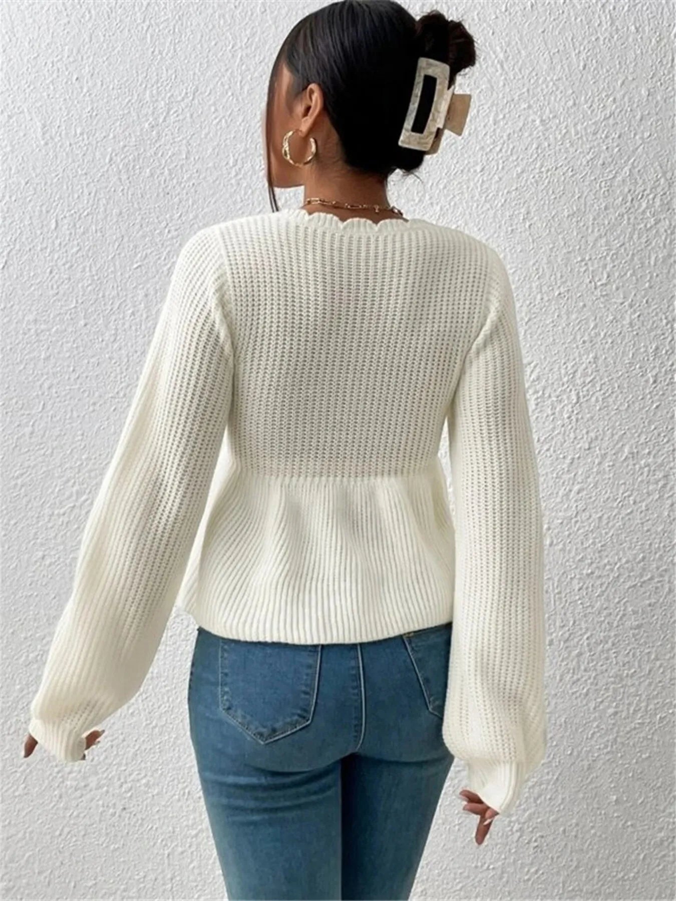 Woman wearing a long sleeve  Scalloped V-Neck Drawstring Knit Top