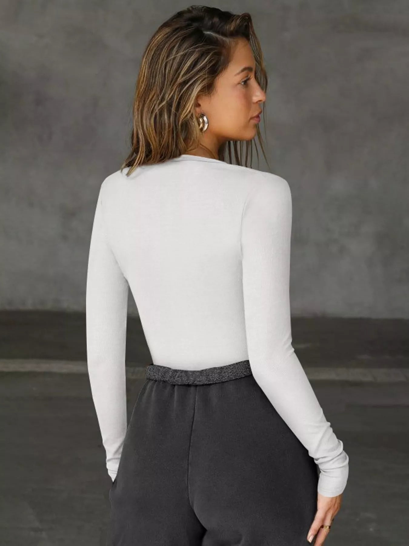 Woman wearing a white v neck long sleeve top