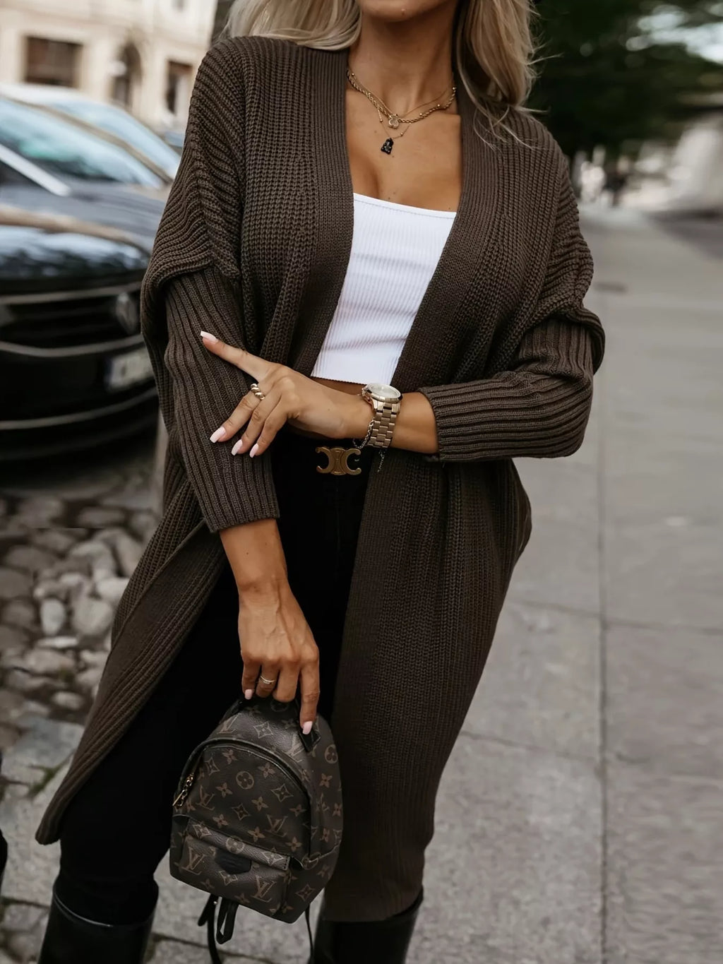 Woman Wearing An Open Front Longline Knit Cardigan