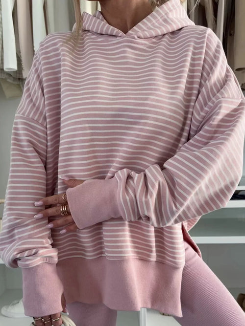 Woman wearing a pink blush stripe thumbhole hoodie
