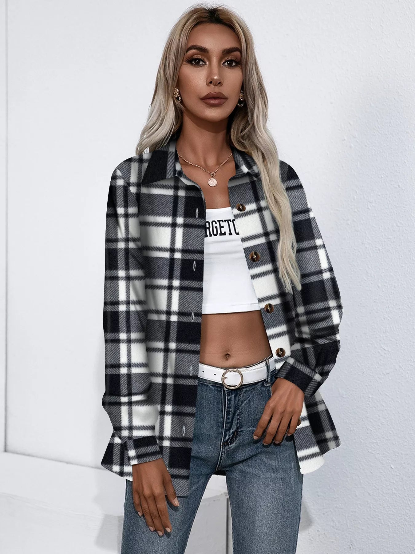 woman wearing a white and black plaid button up jacket