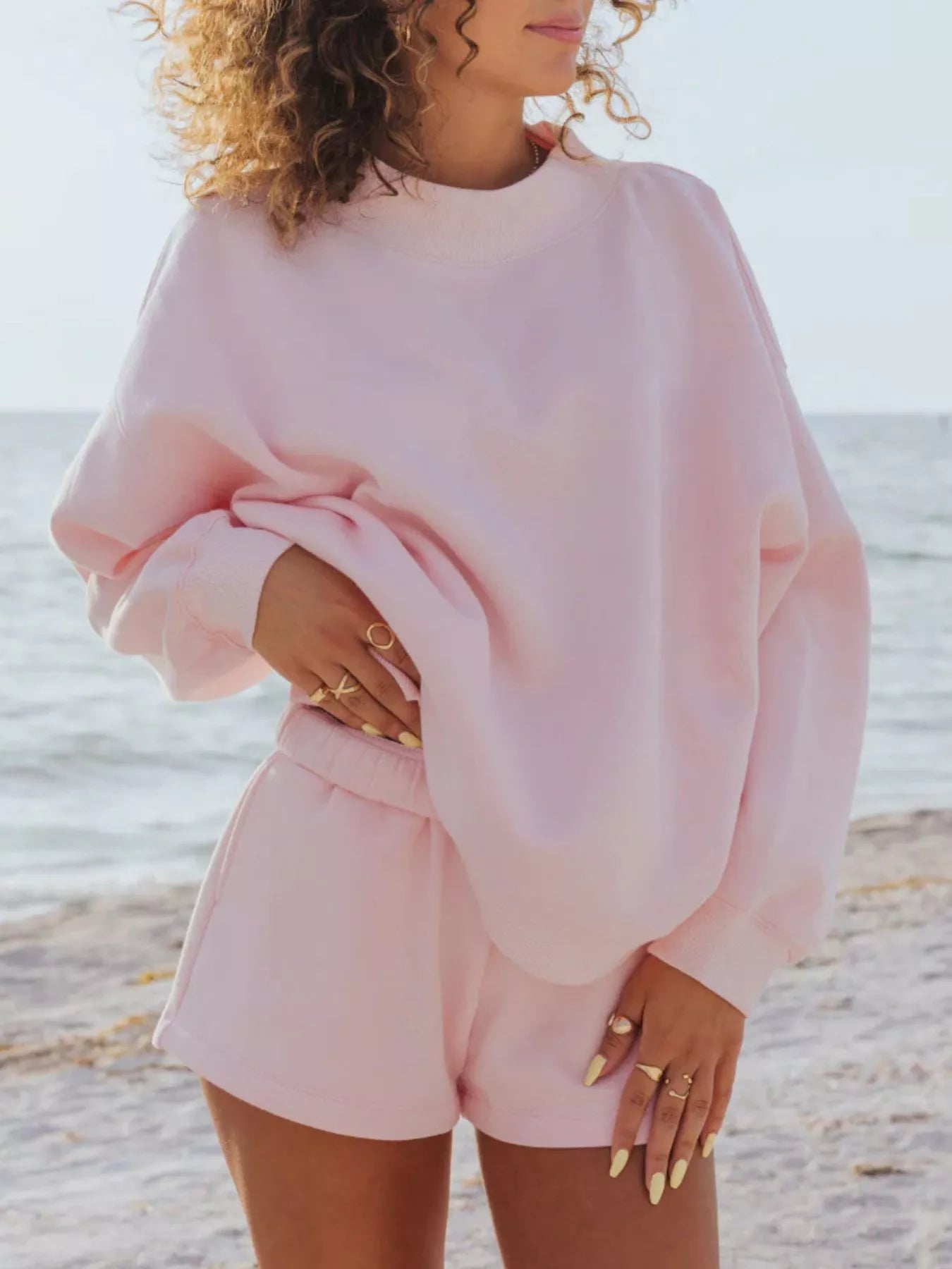 woman wearing a baby pink Relaxed Fit Sweatshirt and Shorts Set 