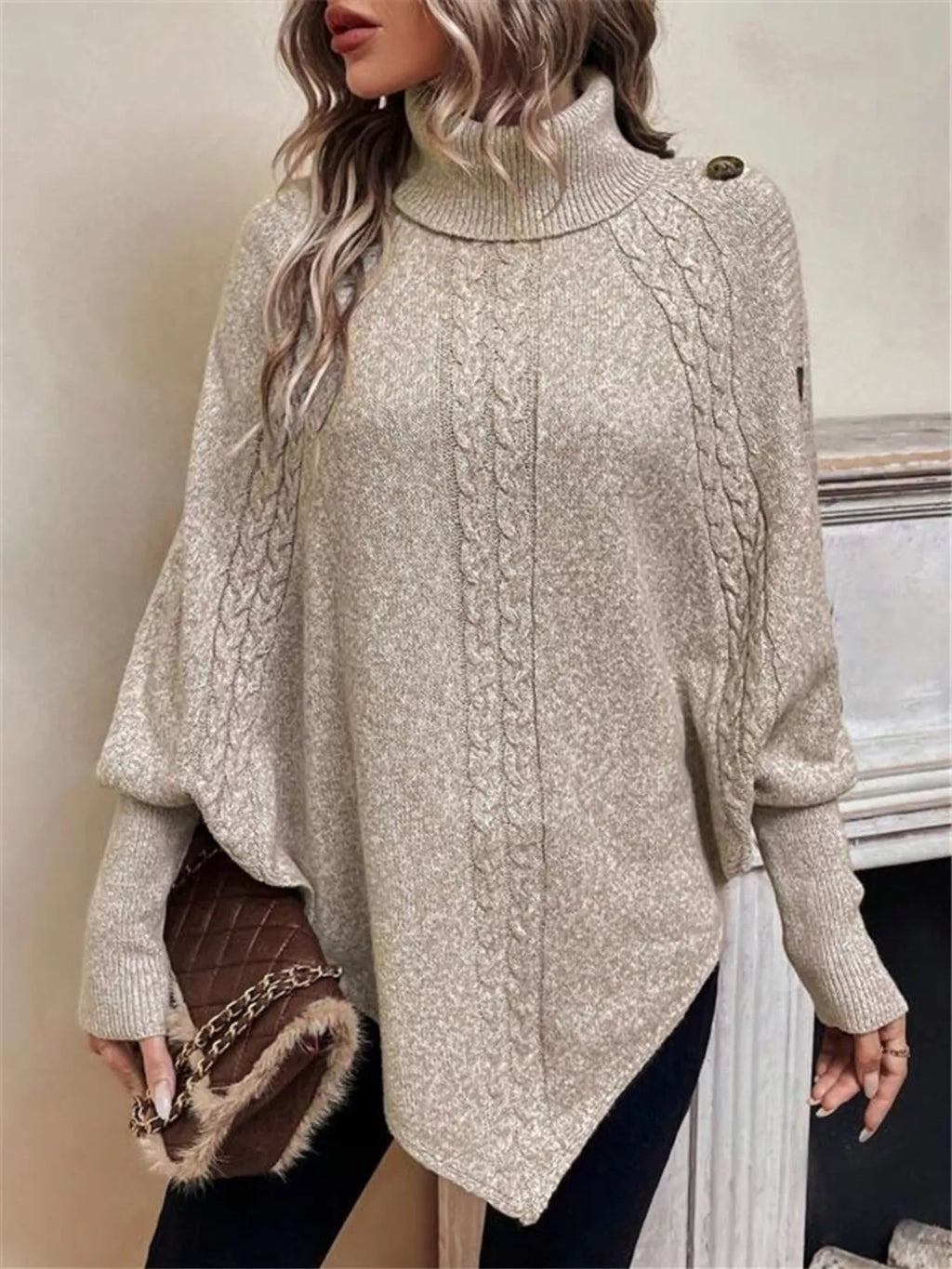 Woman wearing a textured turtleneck cape sweater