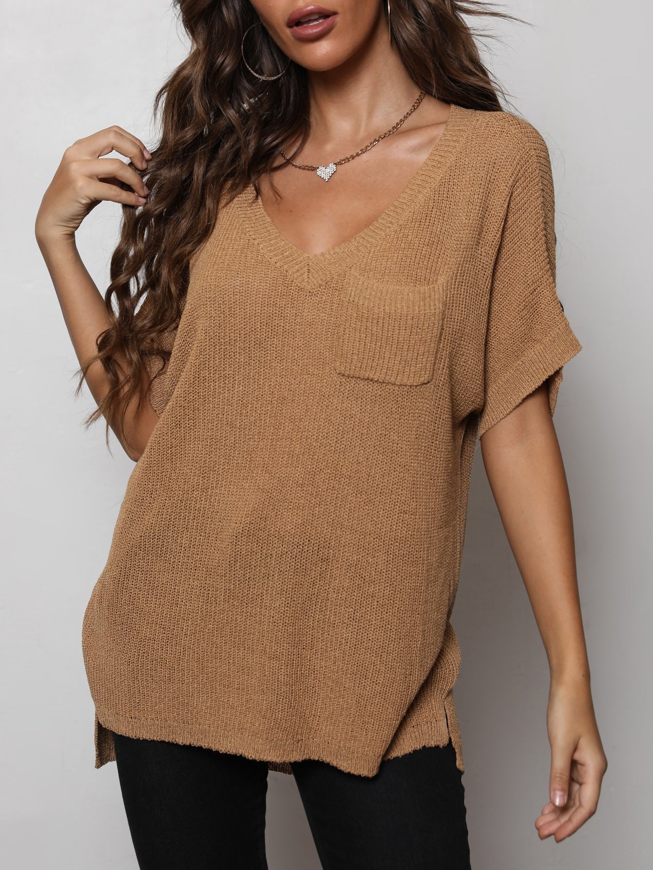 Woman wearing v-neck slit high low knit top