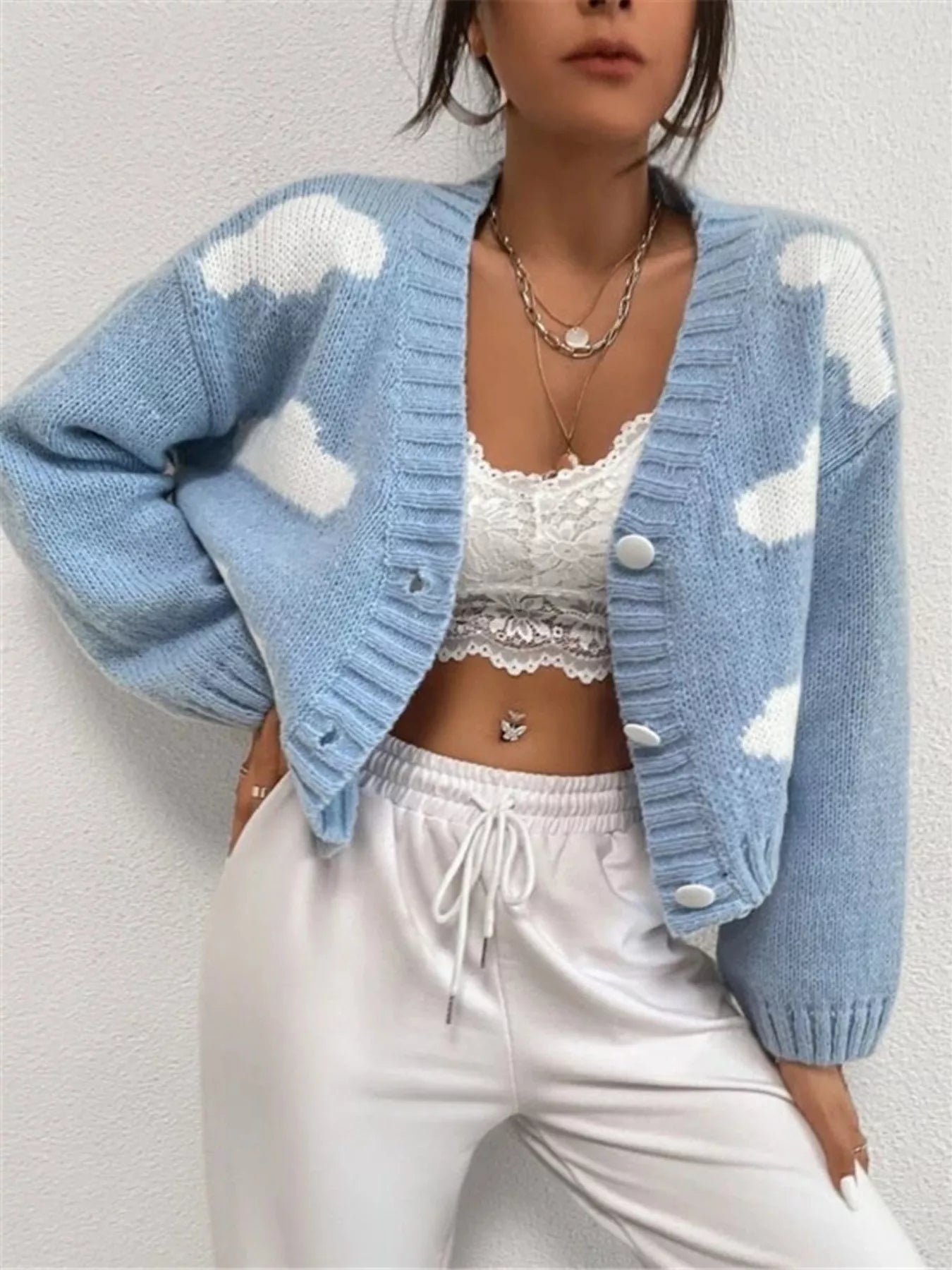 woman wearing a button up cloud pattern fuzzy knit cardigan