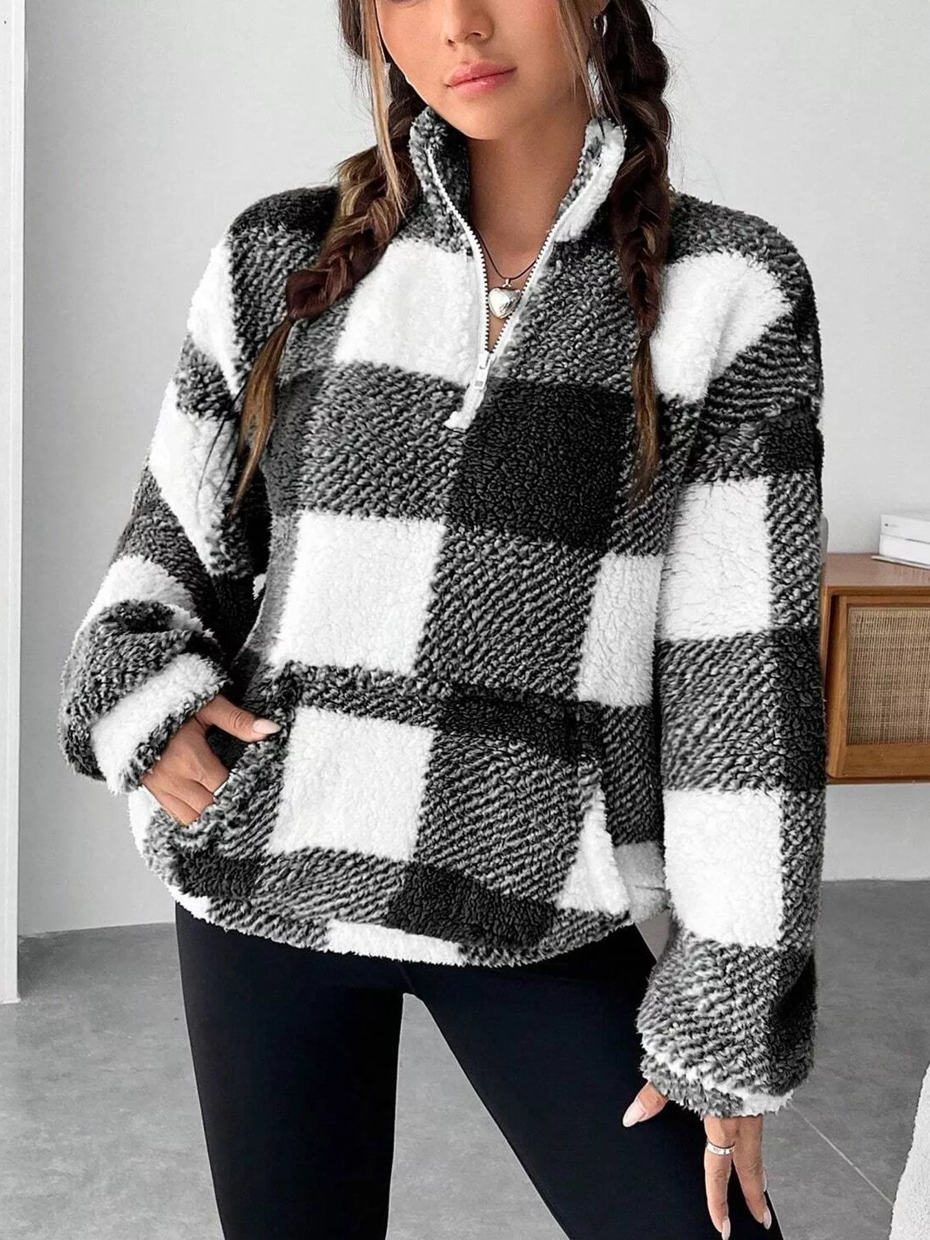 woman wearing a checkered pullover sweater