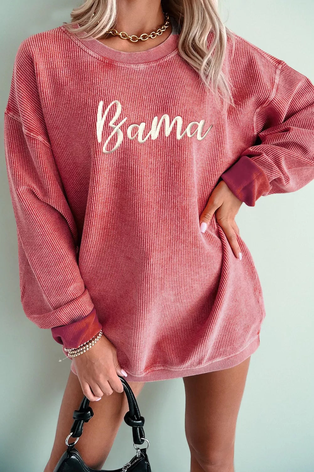 woman wearing corded alabama embroidered sweatshirt