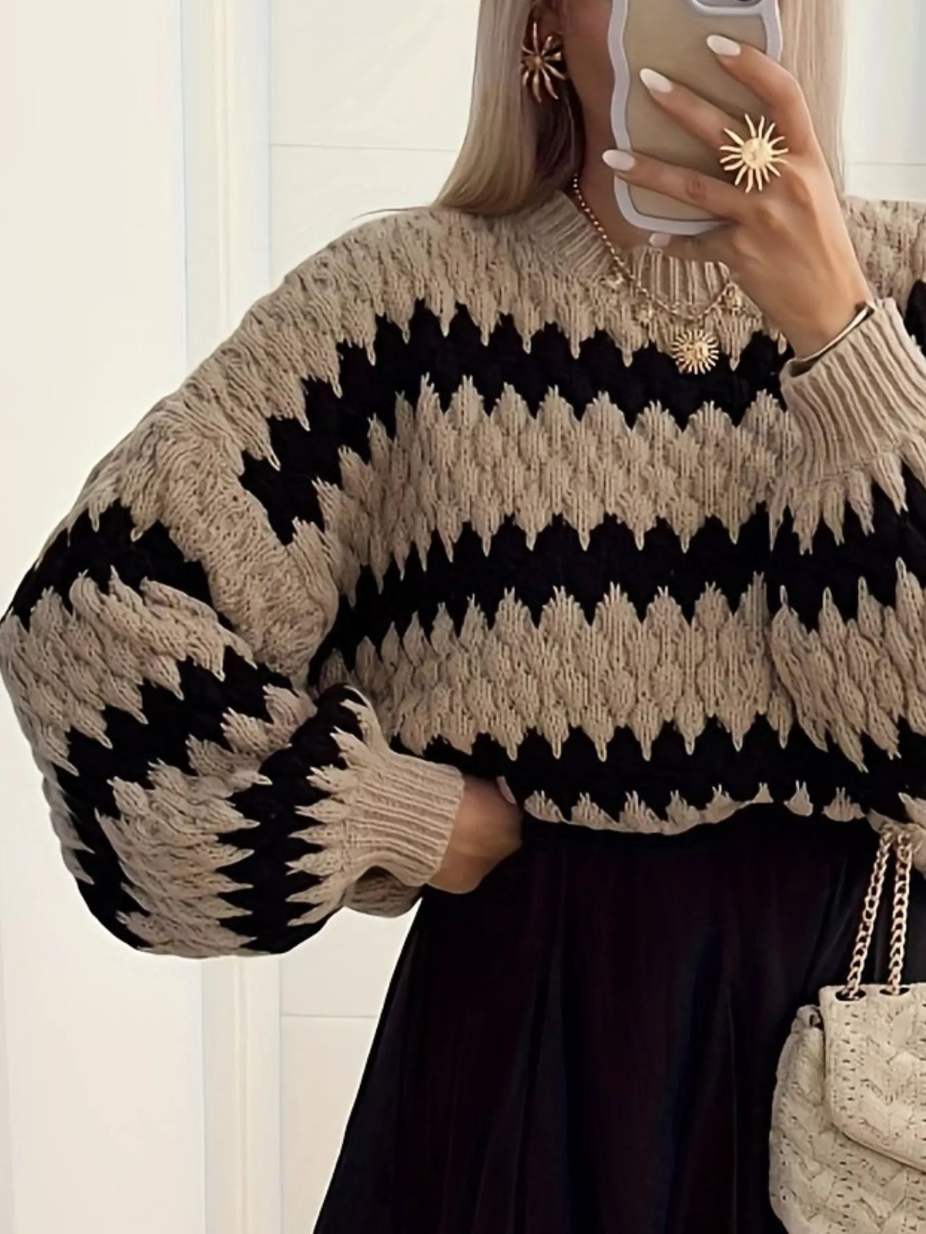 woman wearing a textured knit sweater with stripe pattern