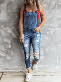 woman wearing distressed denim relaxed fit overalls