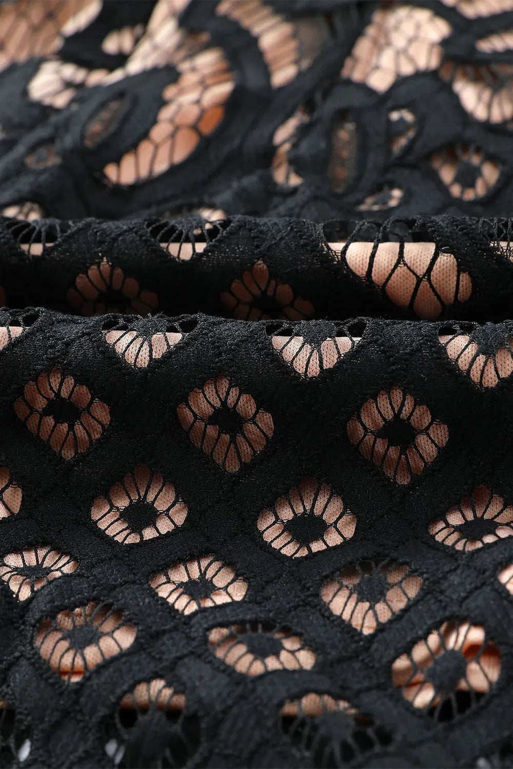 a close up on the material on a lace bodycon dress