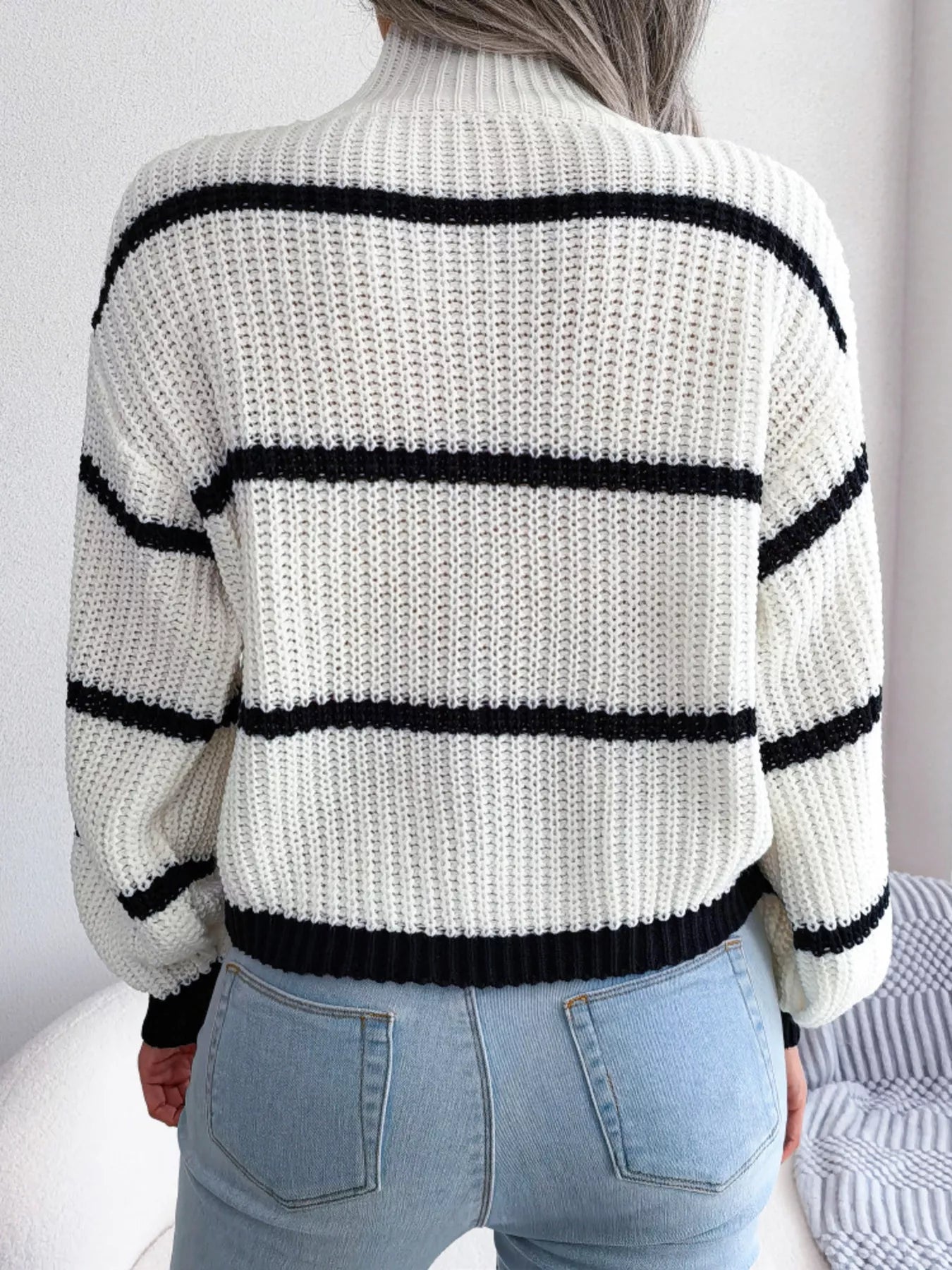woman wearing a striped mock neck knit sweater