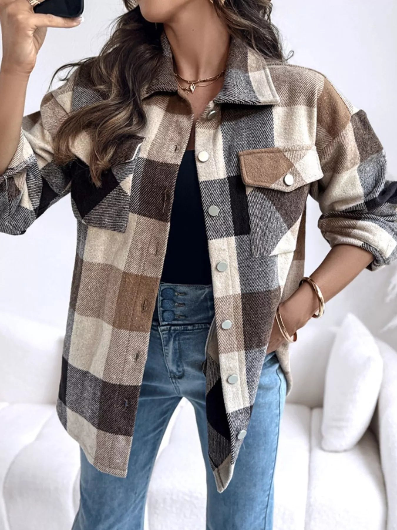 woman wearing a neutral plaid long sleeve button up shirt