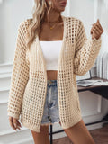 woman wearing an off white open knit cardigan