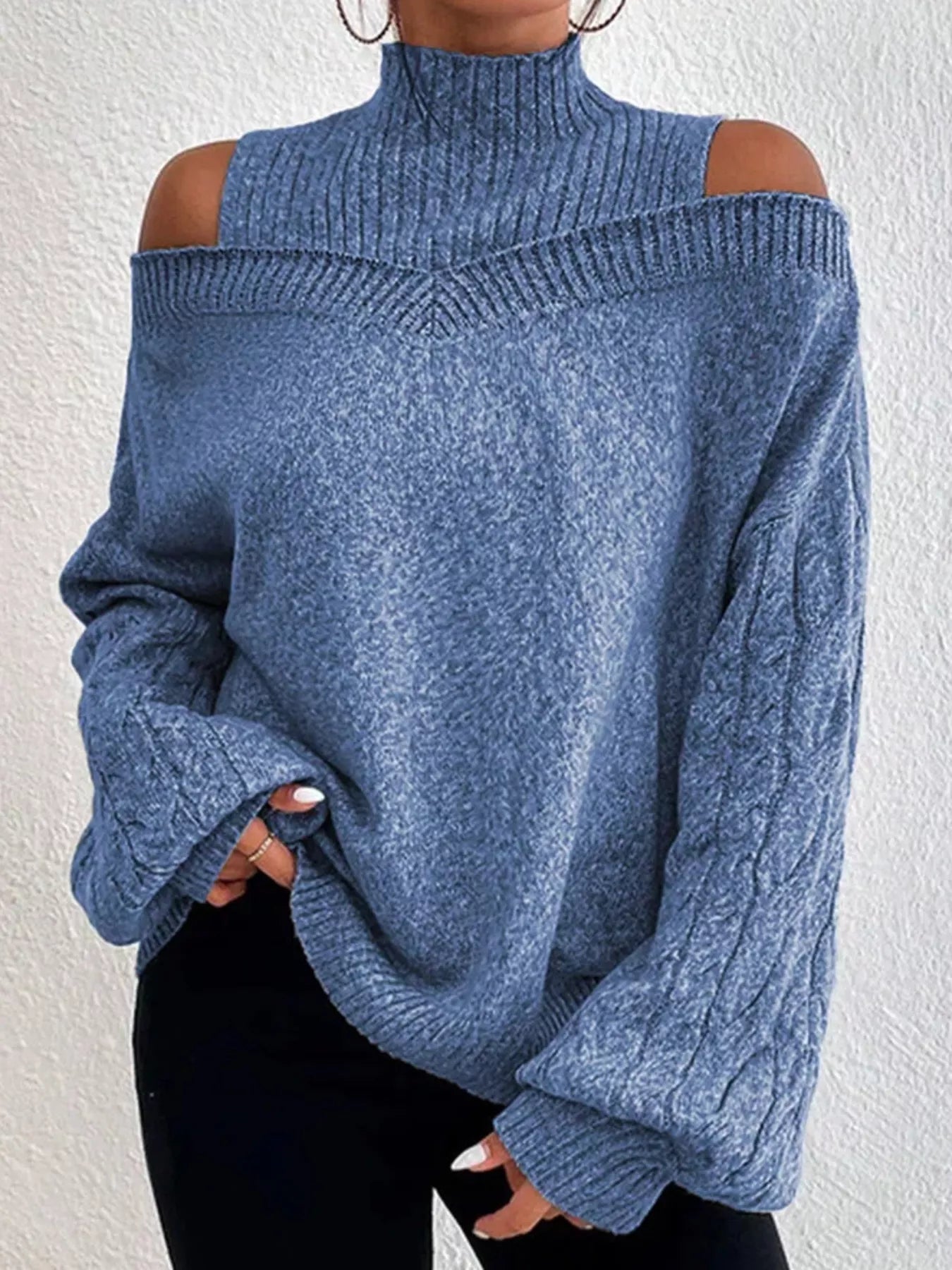 woman wearing an open shoulder turtleneck knit sweater