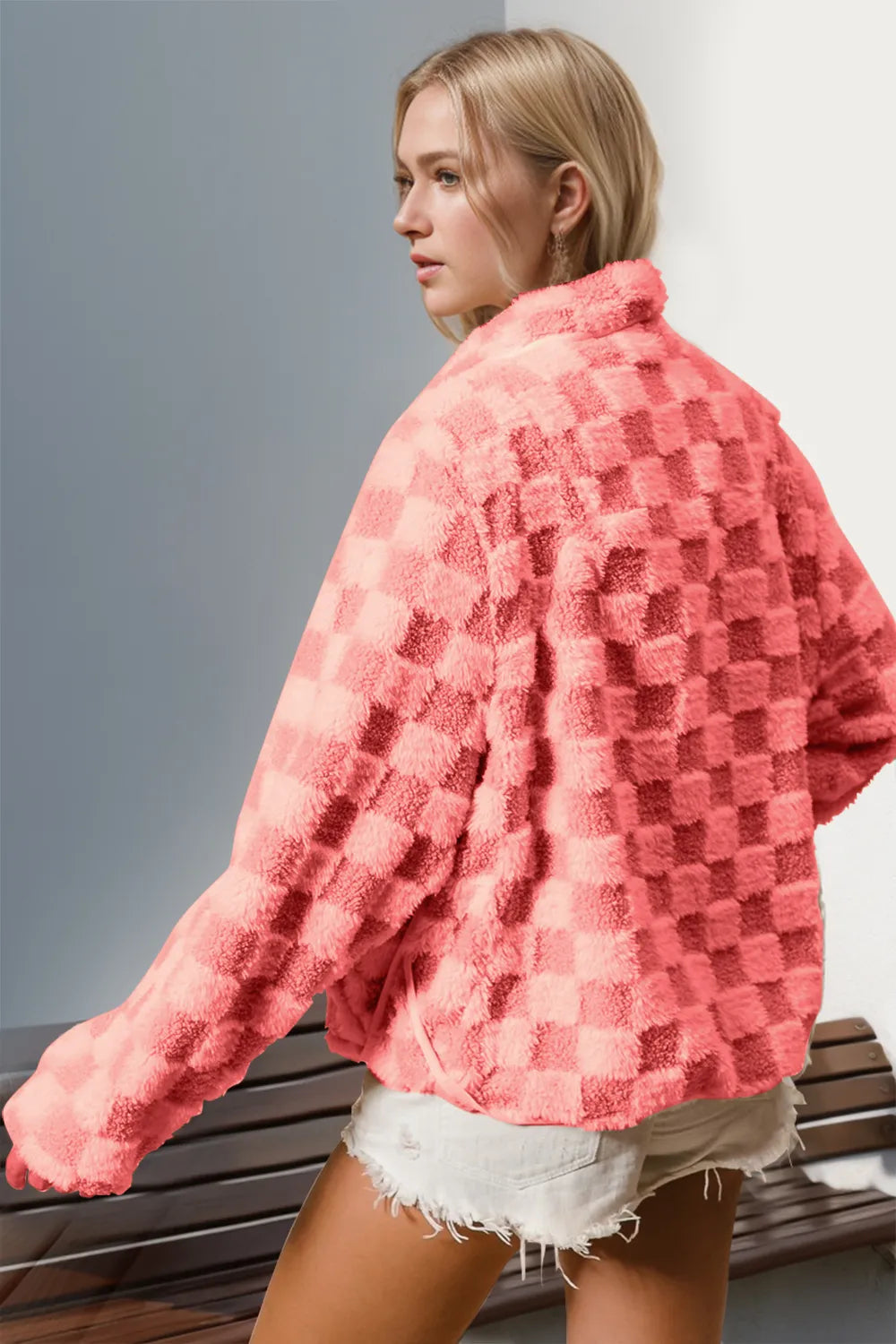 woman wearing a trendy pink checkered plush jacket
