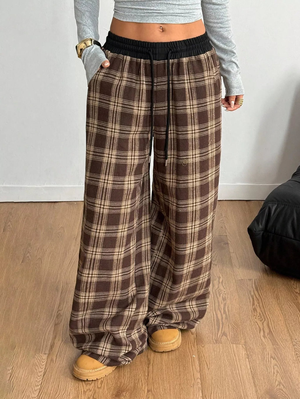 woman wearing plaid drawstring wide leg pants
