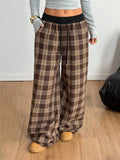 woman wearing plaid drawstring wide leg pants