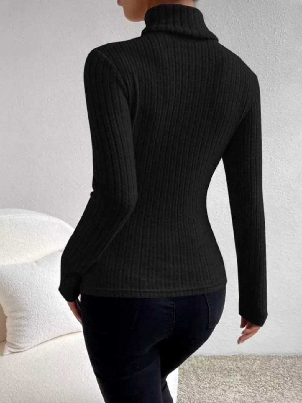 woman wearing a ribbed black turtleneck 