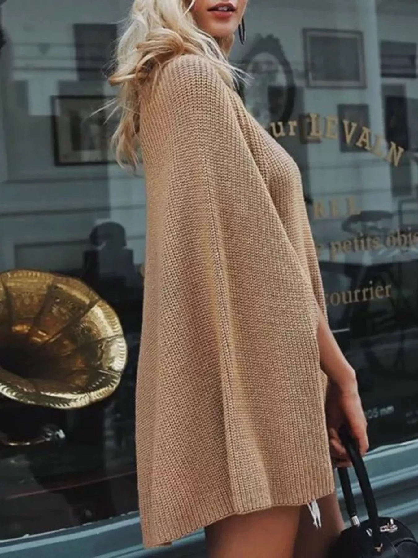 woman wearing a ribbed turtle neck cape sweater