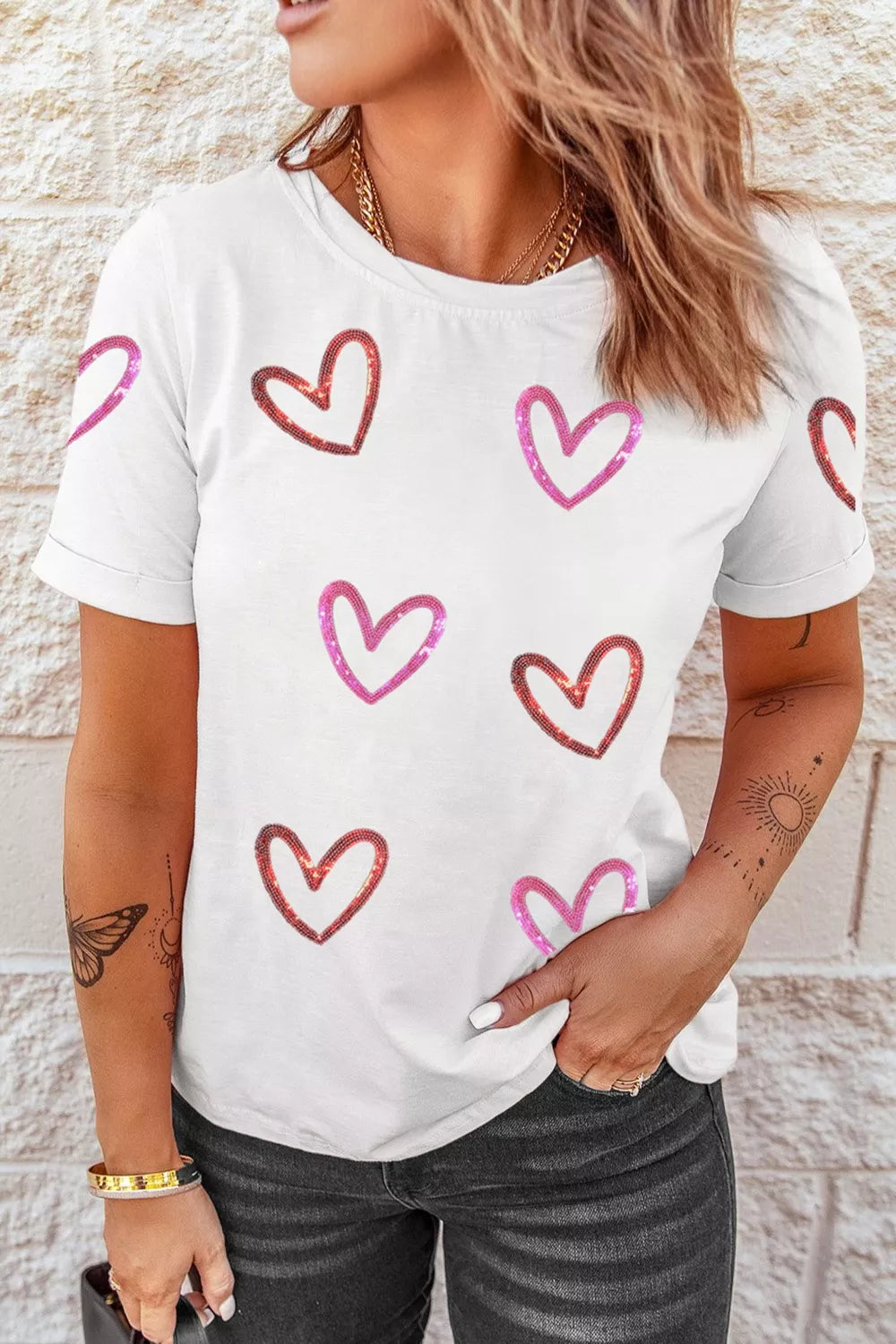 woman wearing a casual tee with sequin hearts