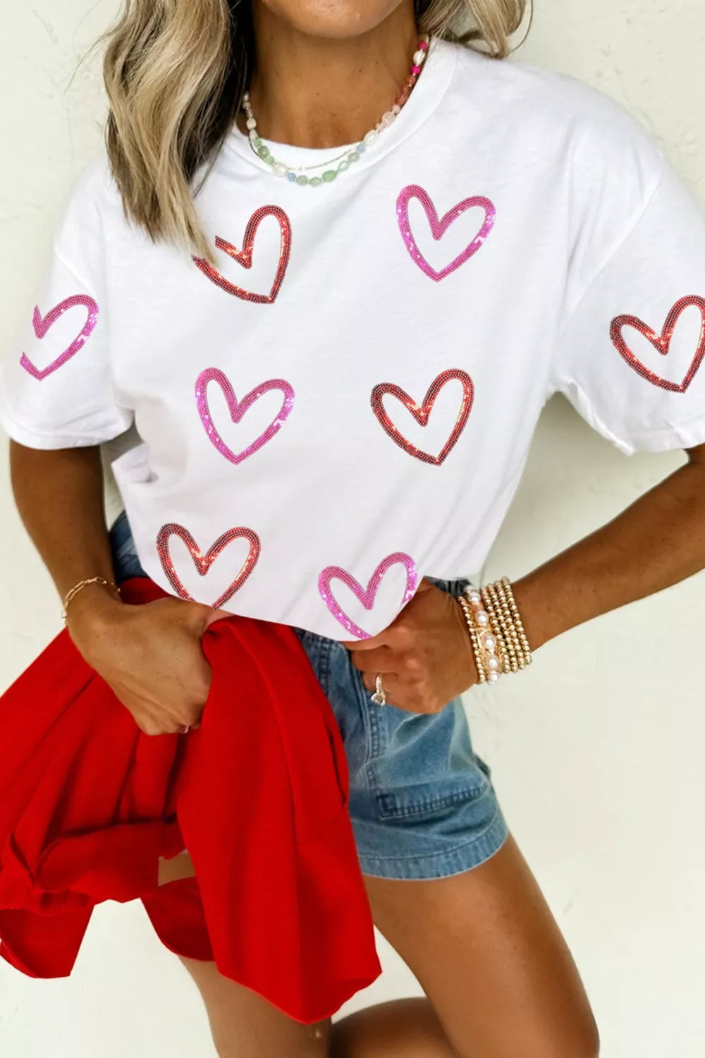 woman wearing a sequin heart pattern graphic tee