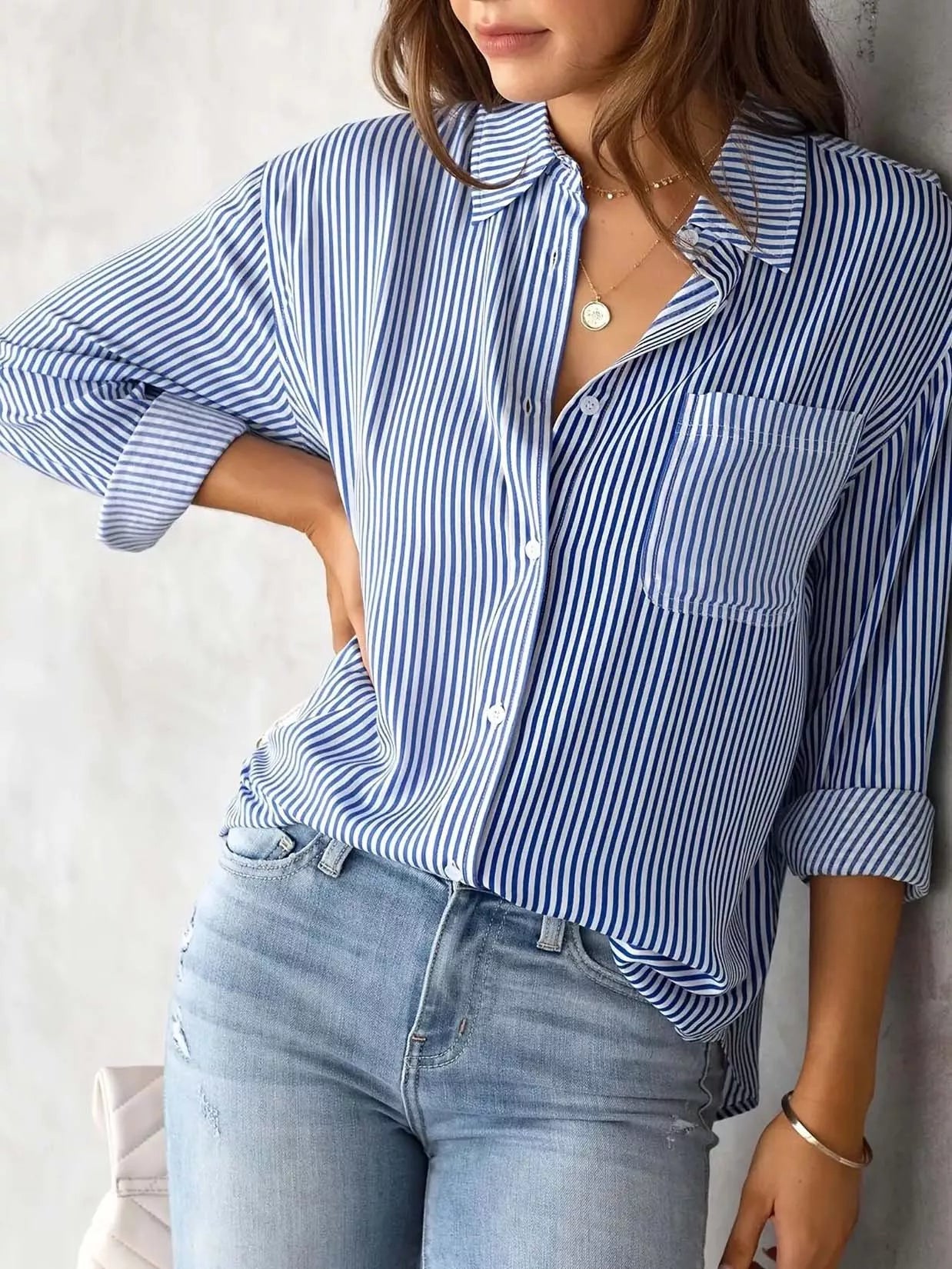 woman wearing a striped button up blouse