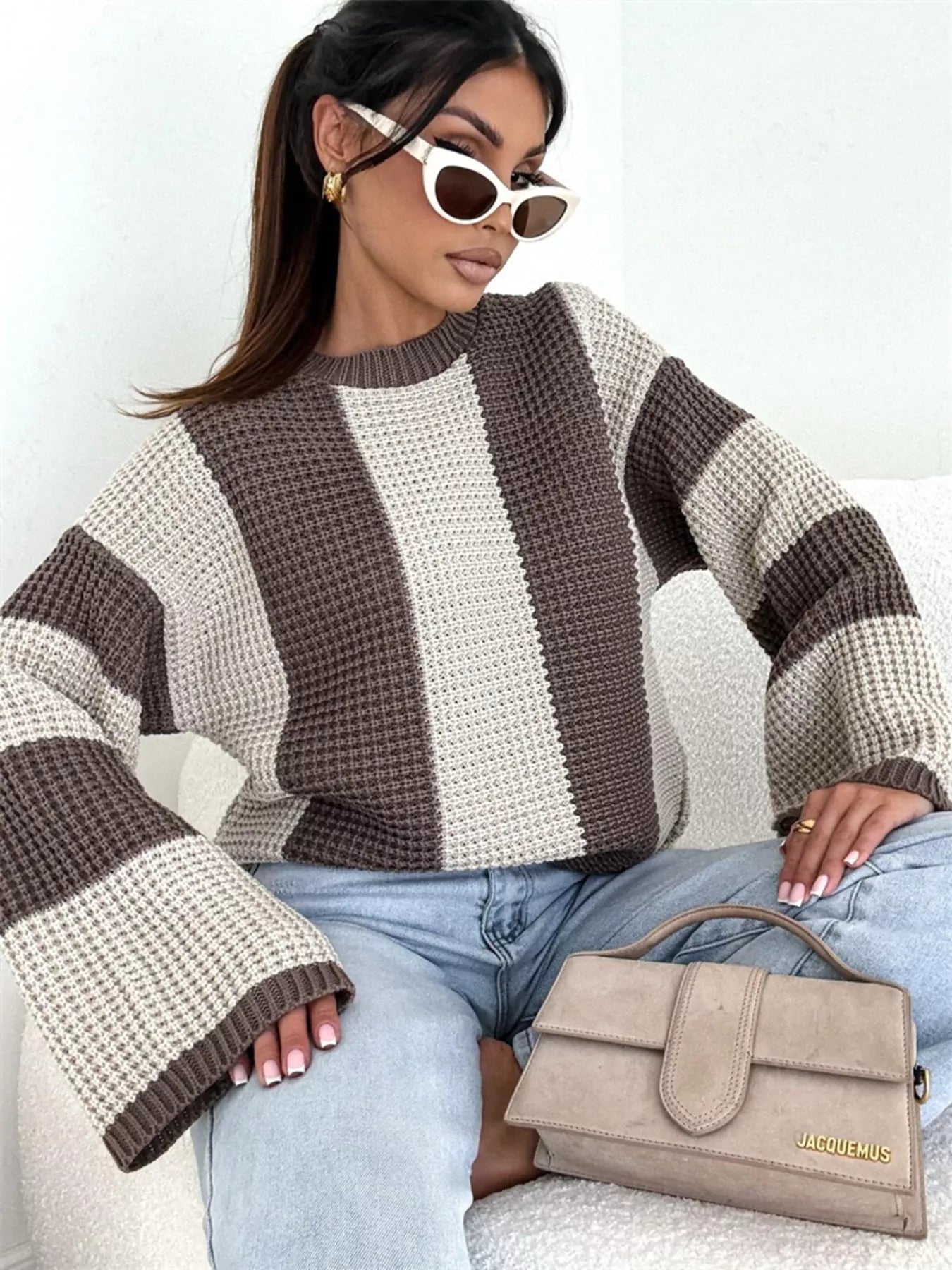 woman wearing a striped oversized color block knit sweater