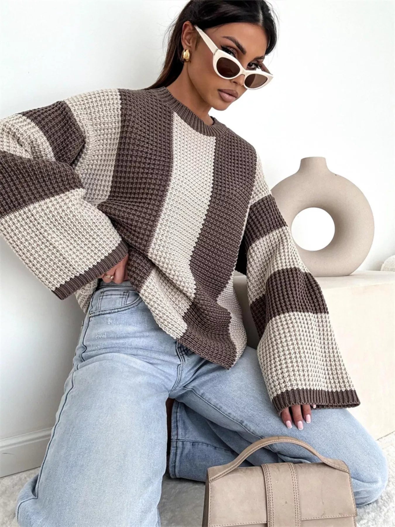 woman wearing a striped oversized knit sweater