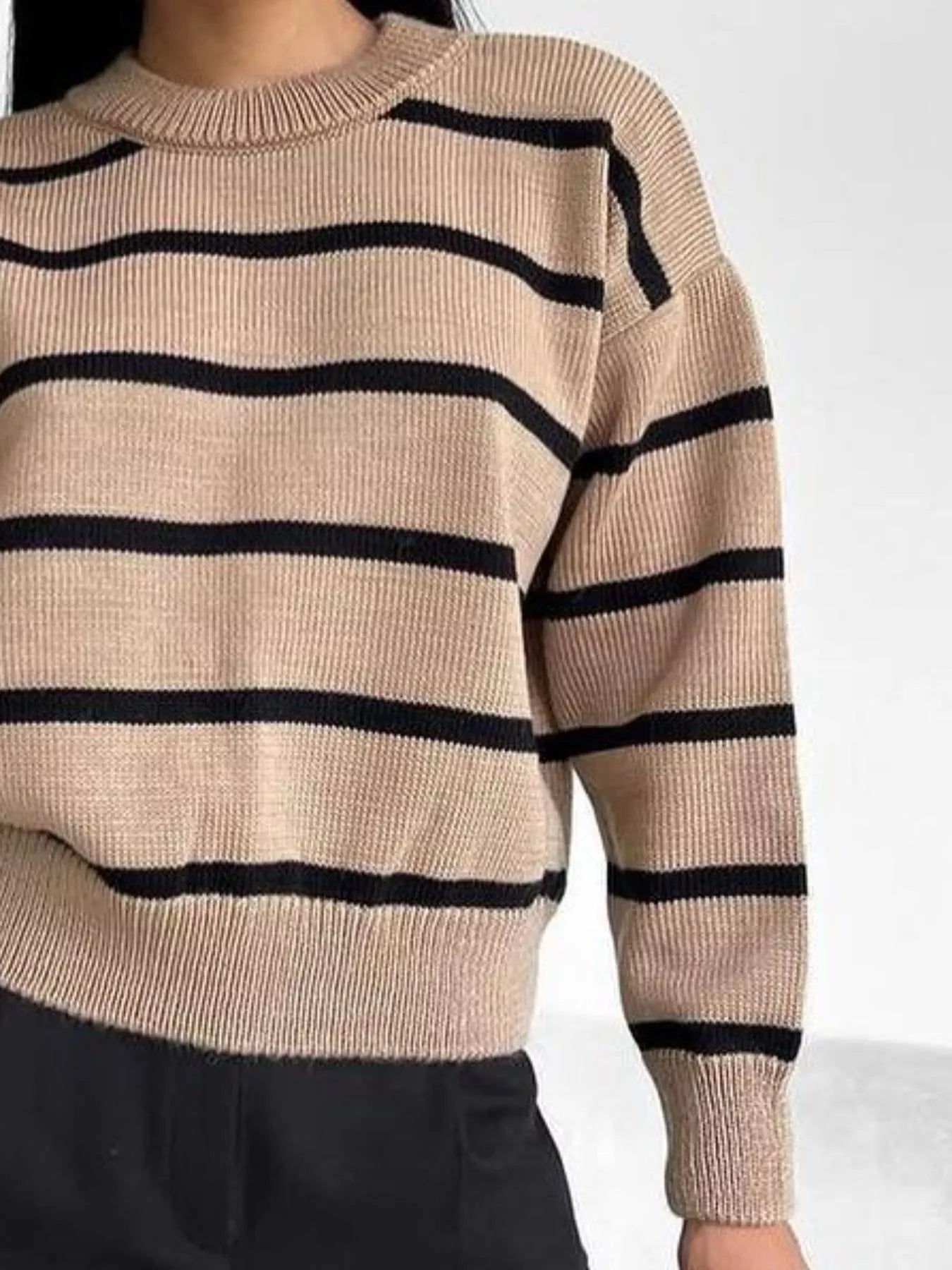 woman wearing a thick neutral striped sweater