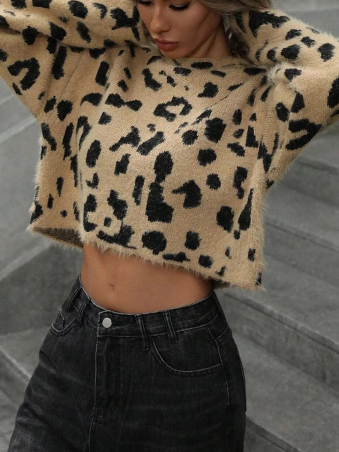 woman wearing a trendy fuzzy leopard pattern knit sweater