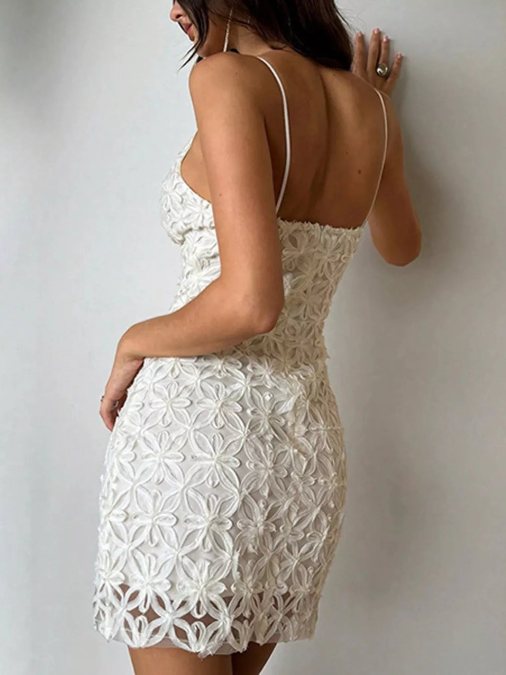 woman wearing a white lace bodycon mini dress