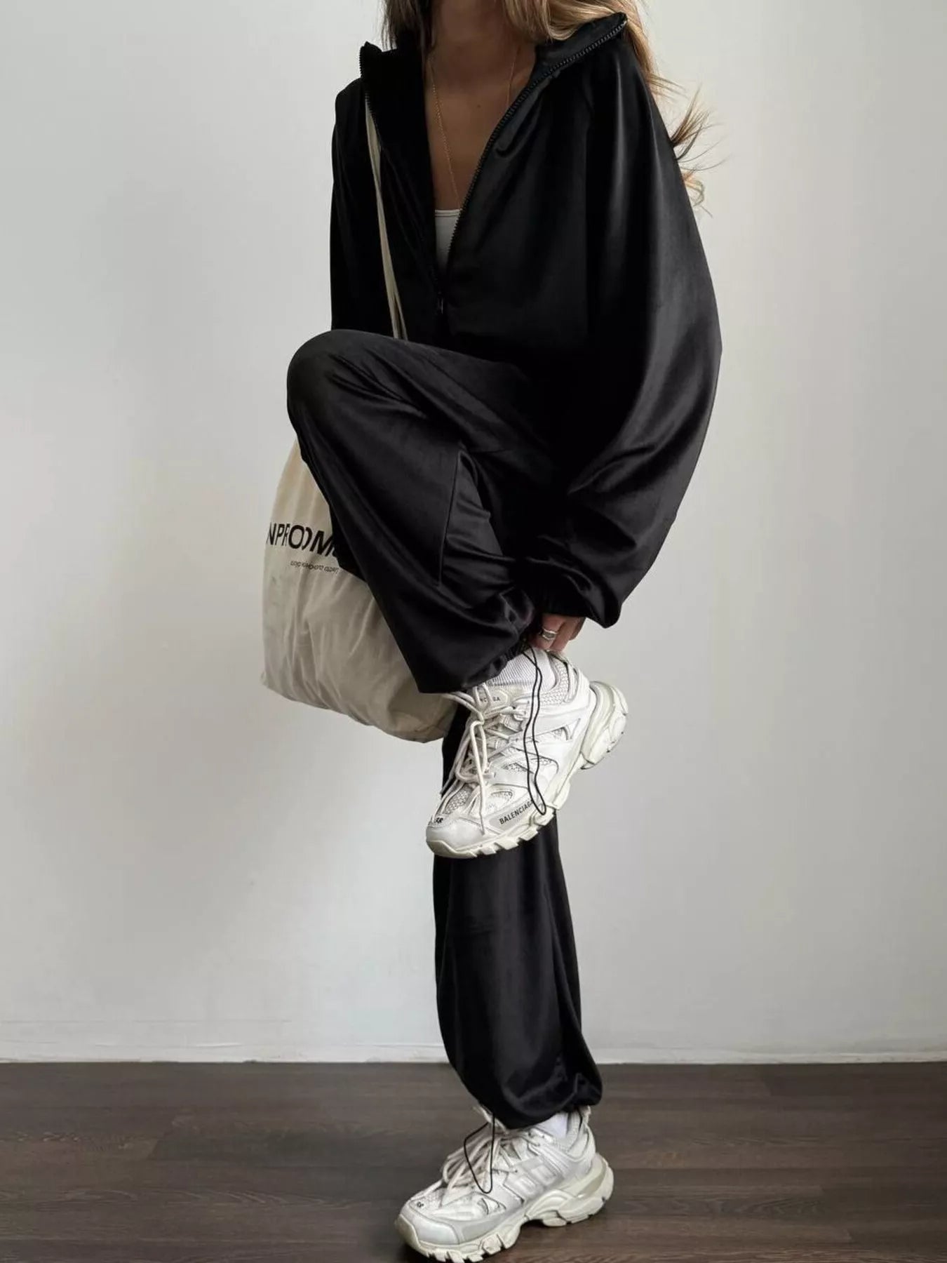 woman wearing a zip up jacket and pants set